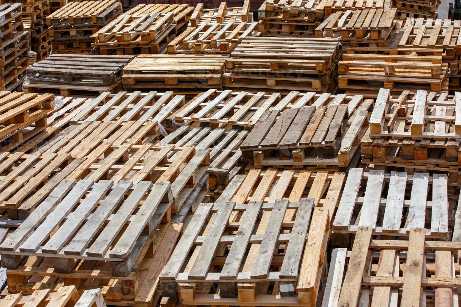 full frame background of used wooden pallet stacks - perspective view from above photo