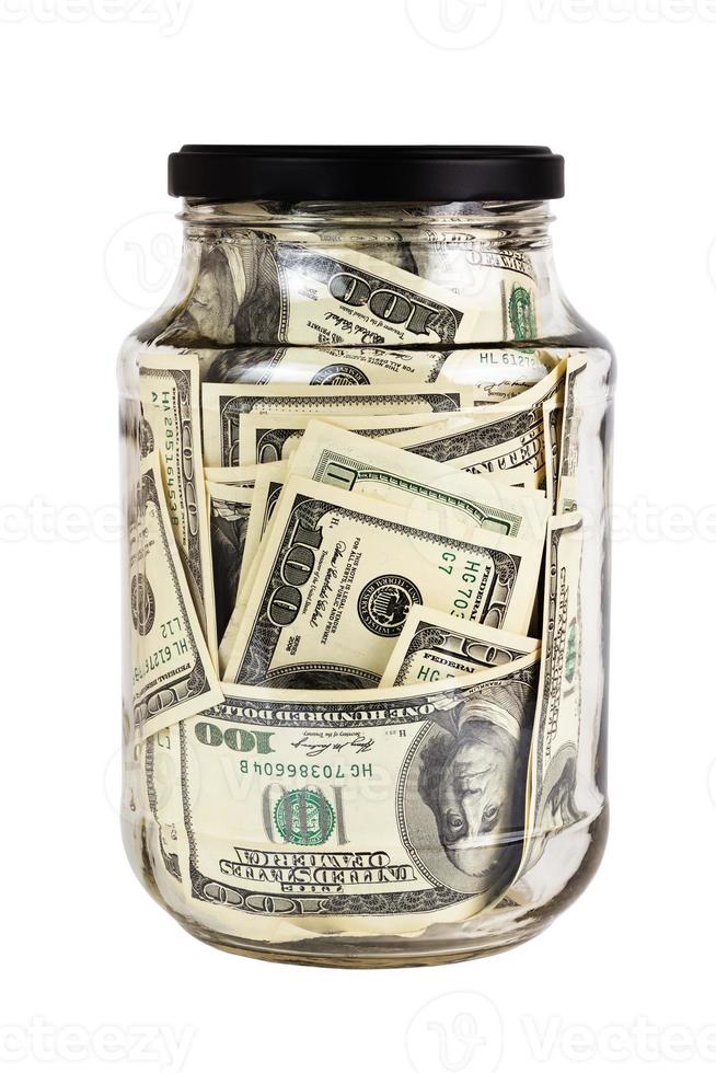 A hundred US dollars bank notes in a glass jar with black cap isolated on white background photo