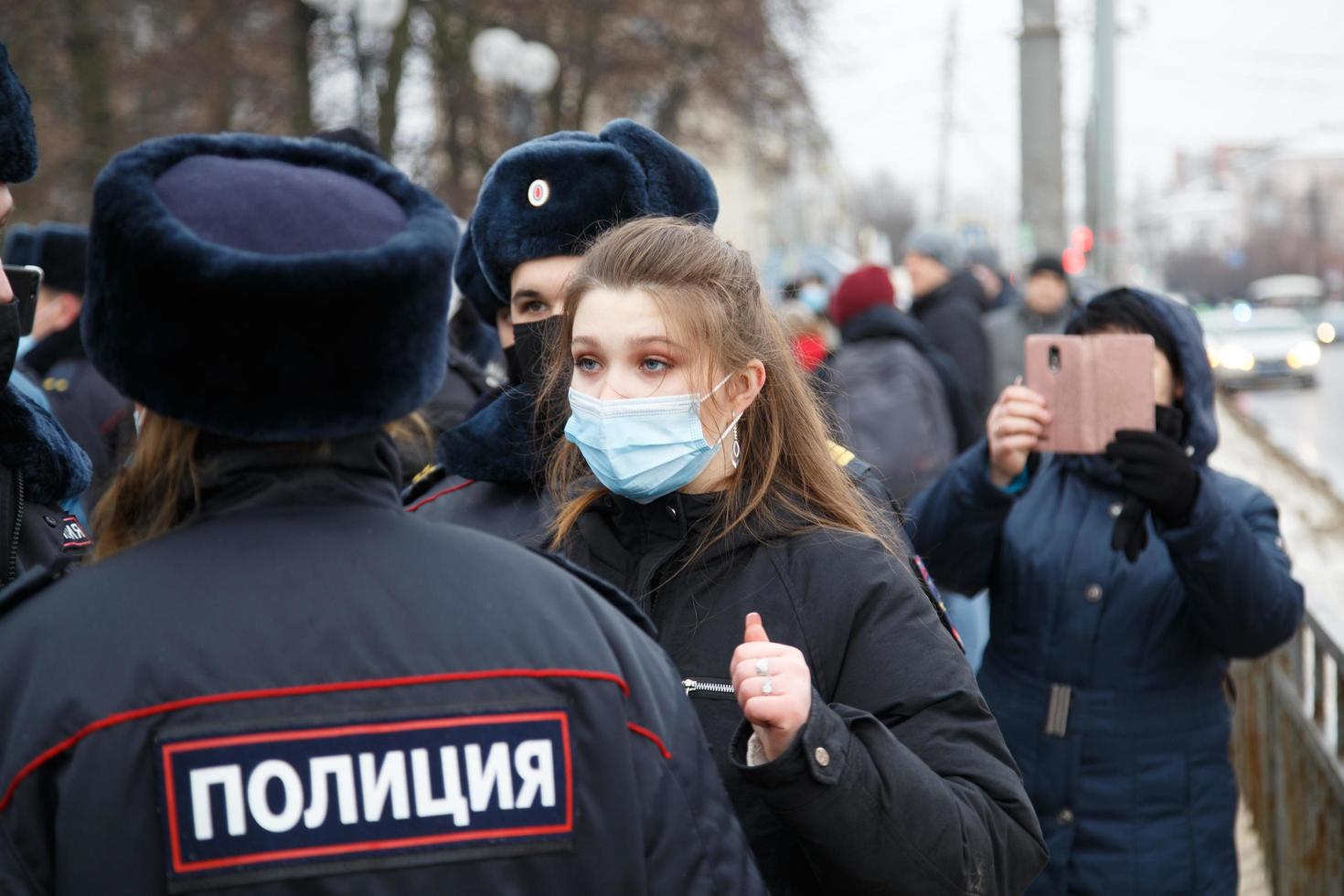 TULA, RUSSIA  JANUARY 23, 2021 Public mass meeting in support of Alexei Navalny, pretty underage girl argues with the police. photo