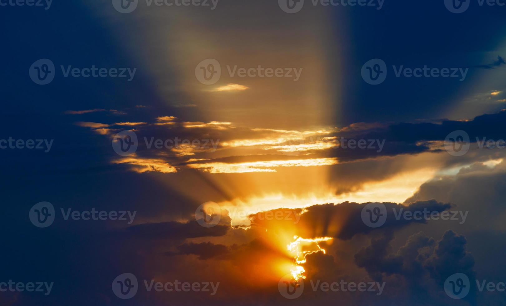 cloudy sunset sky with yellow sun rays without horizon photo