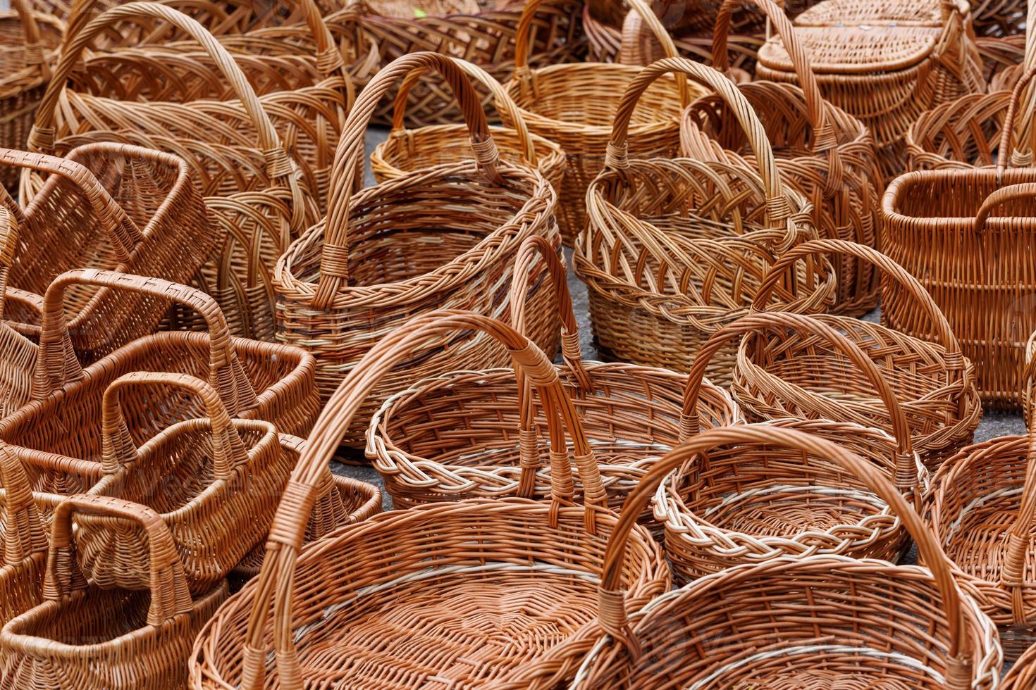 A lot of of many wicker baskets for sale - closeup full-frame background photo