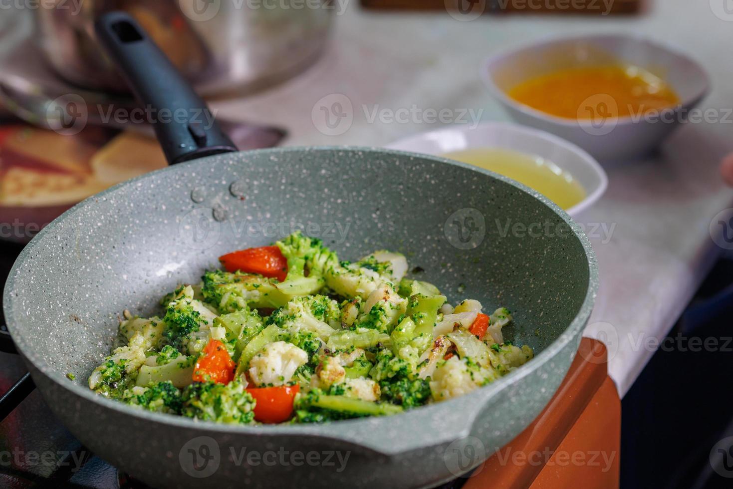 close-up view of frying vegetables in pan without lid photo