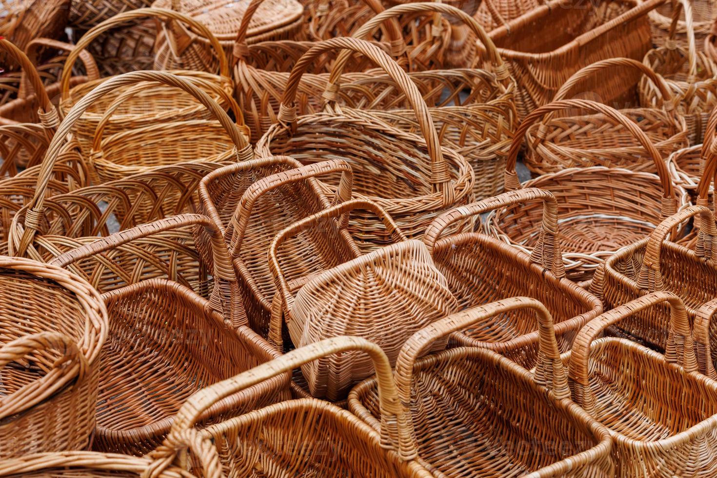 A lot of of many wicker baskets for sale - closeup full-frame background photo