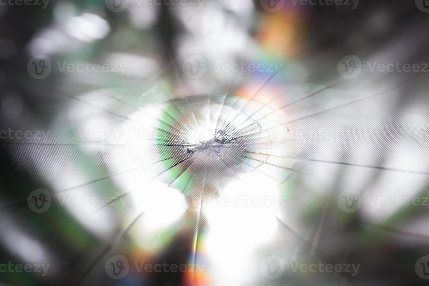 abstract background of broken tft lcd with localized radial cracks from one hit - close-up with selective focus and blur photo