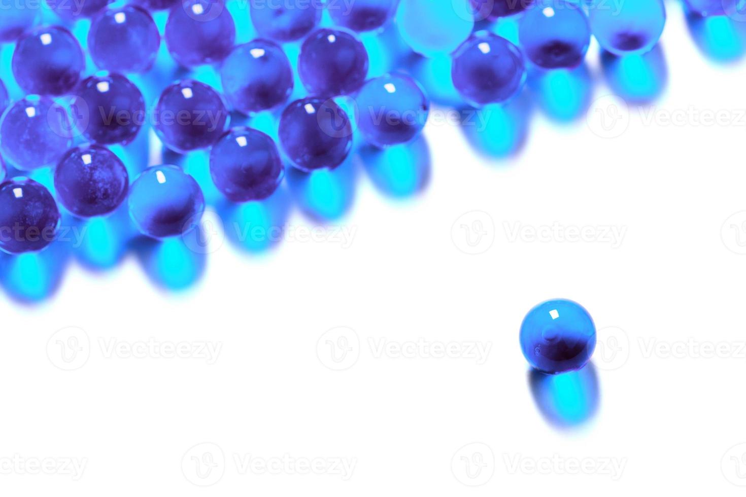 cyan spherical ball capsules with selective focus isolated on white background photo