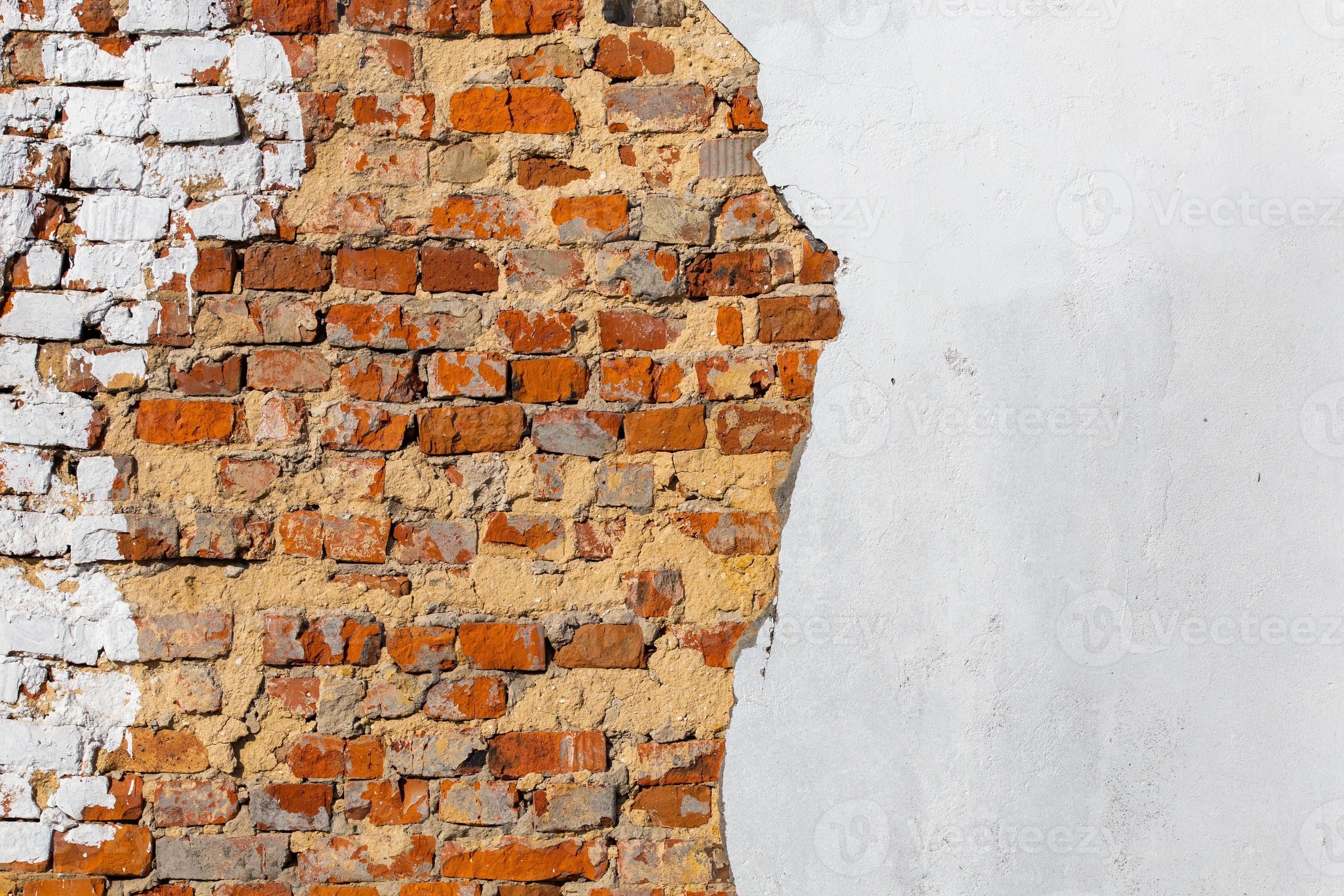 old bad brick wall with leftovers of white peeled thick plaster 12630155 Stock Photo at Vecteezy
