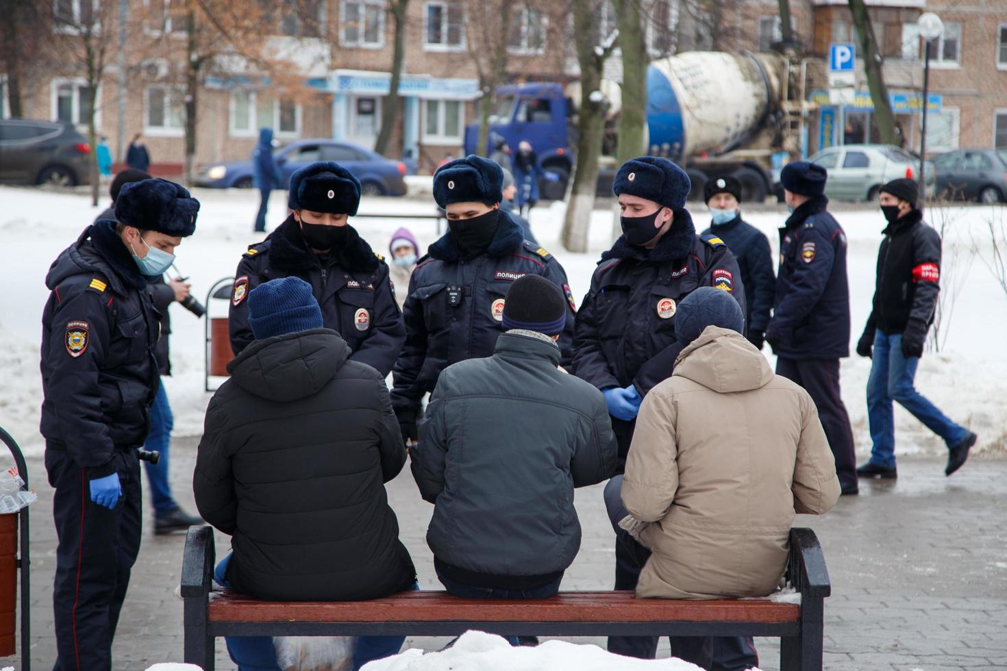 TULA, RUSSIA  JANUARY 23, 2021 Public mass meeting in support of Alexei Navalny, police officers talking with citizens on bench in park. photo