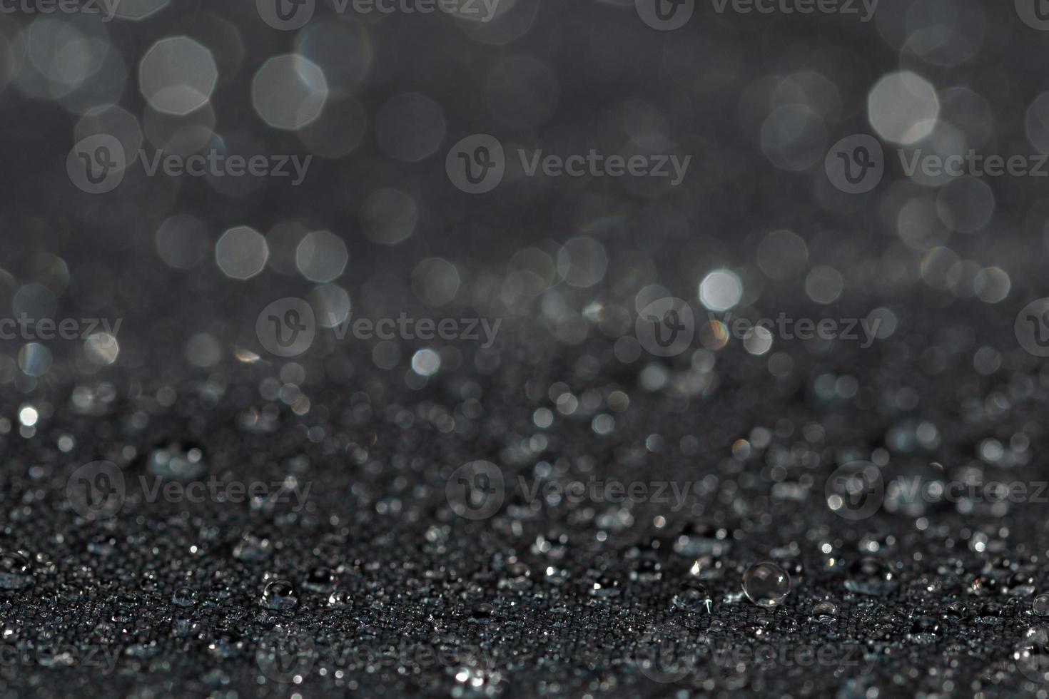 dark gray waterproof hydrophobic flat cloth closeup with rain drops photo