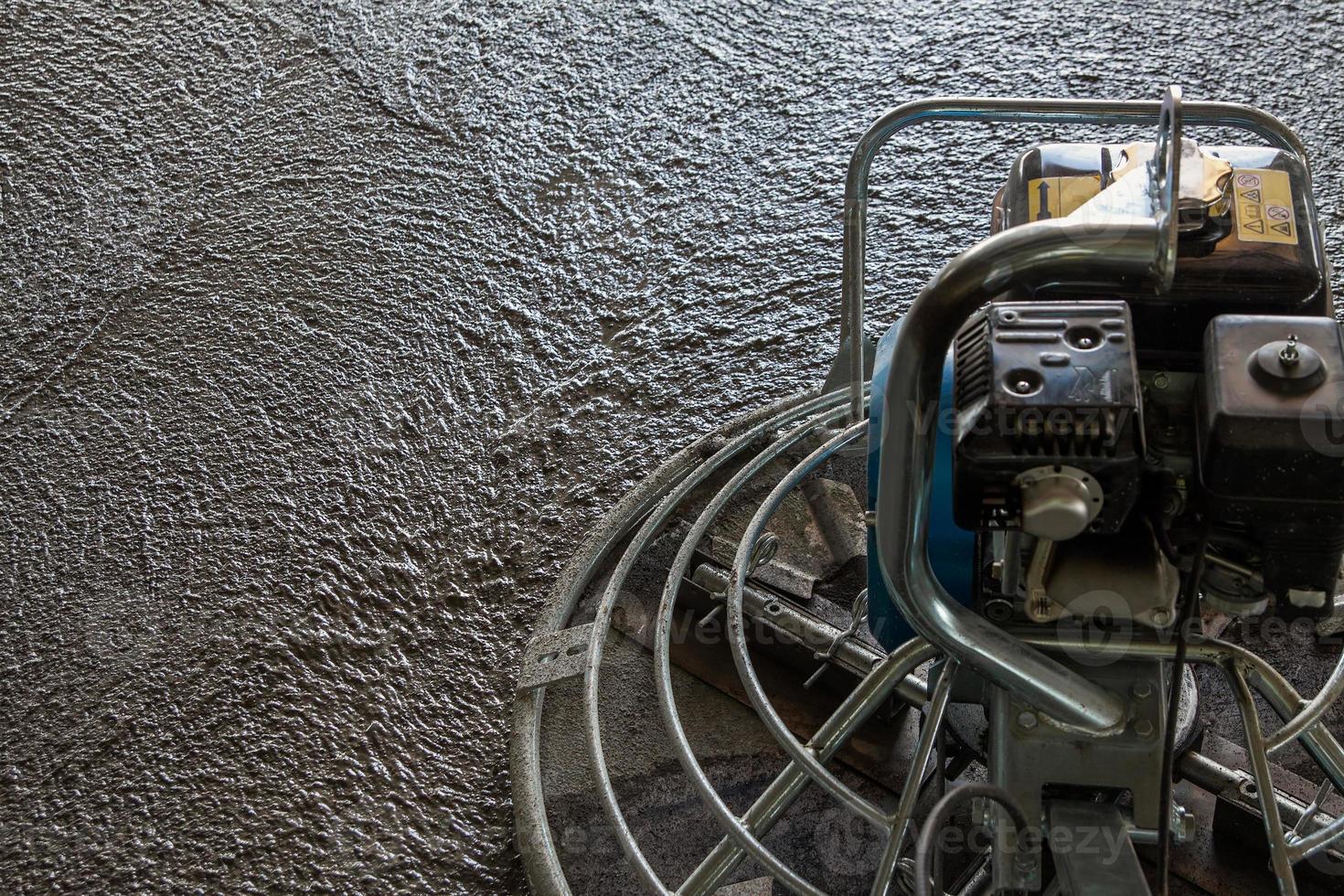 Wet concrete grinding trowel machine - close-up with selective focus photo