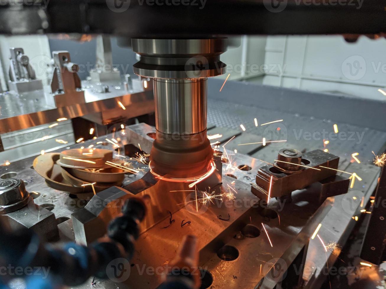 cnc milling of hardened steel with sparks - closeup with selective focus and blur photo