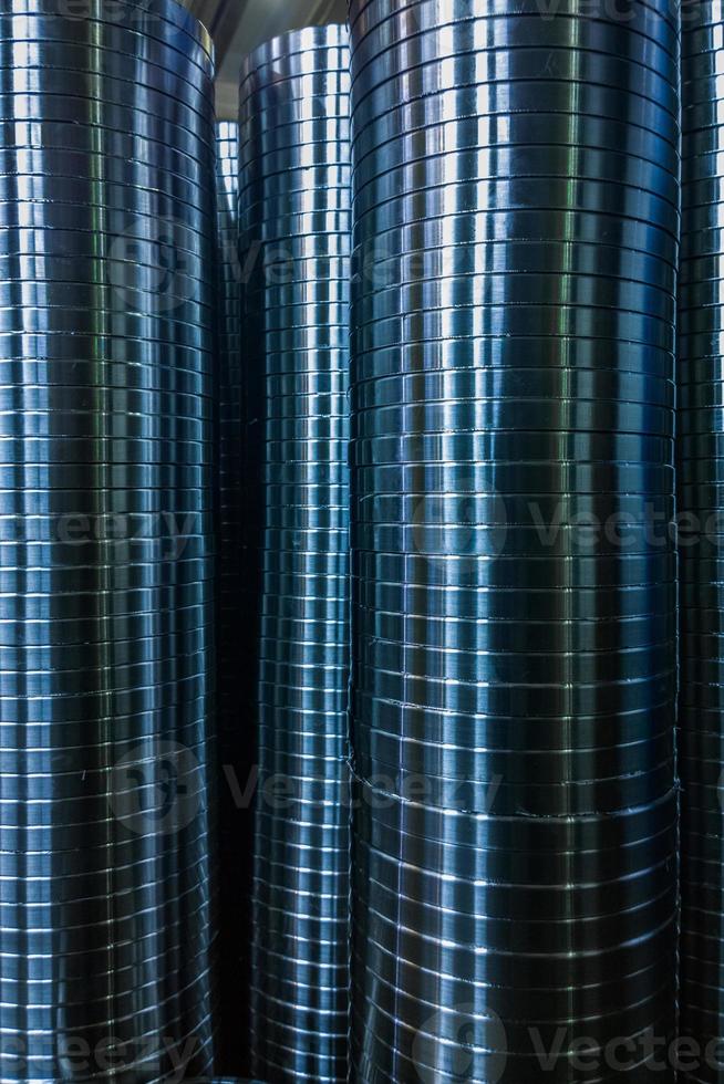 industrial manufacturing background of columns of shiny metal rings after cnc turning operation photo