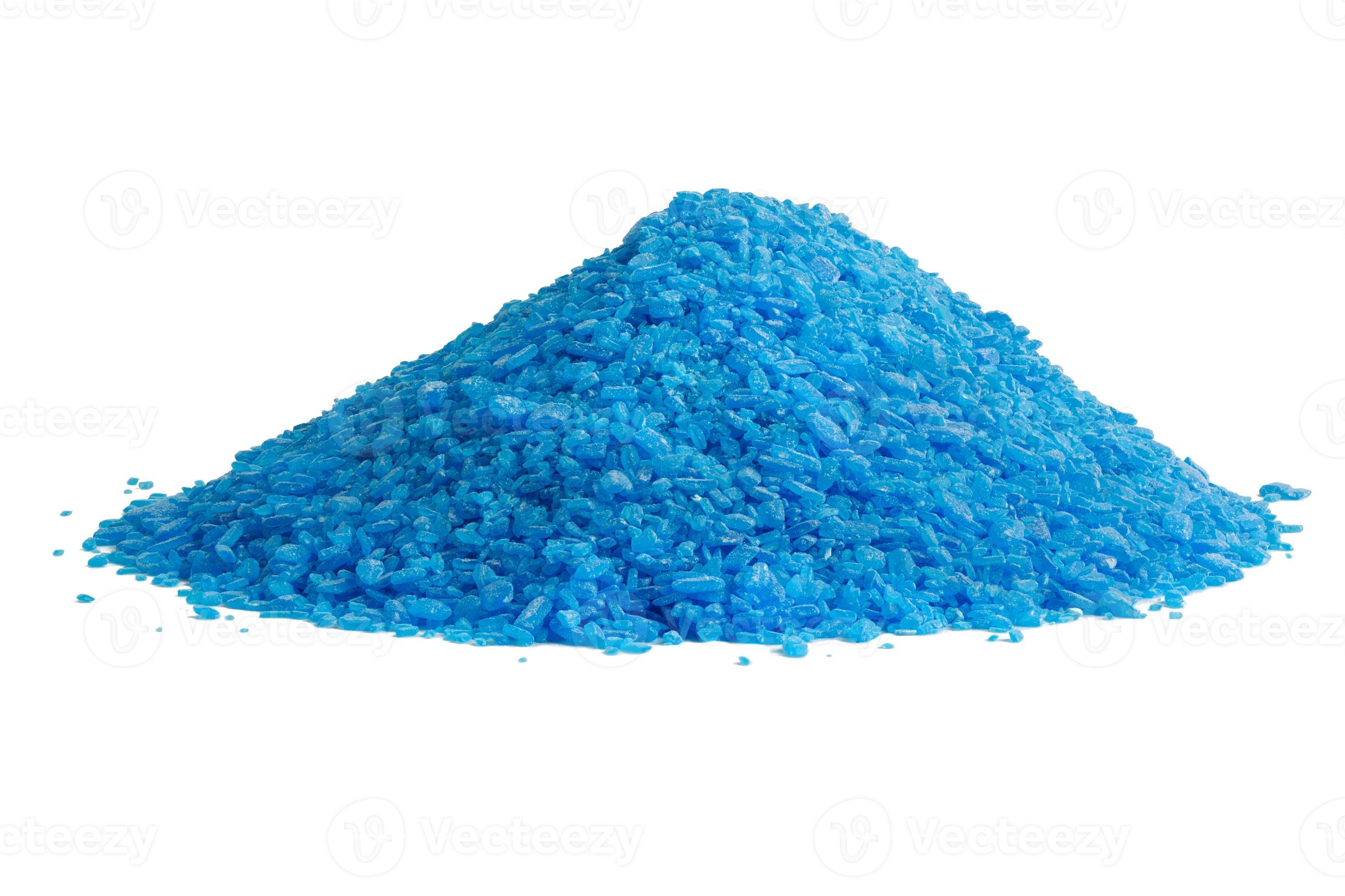 pile of blue copper sulfate granules closeup isolated on white