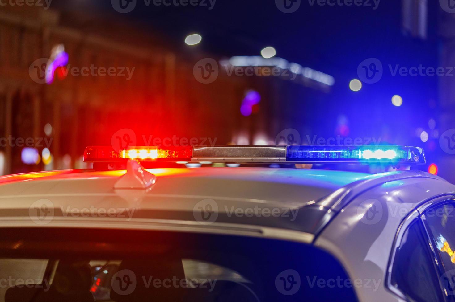 police car lights at night in city with selective focus and bokeh photo