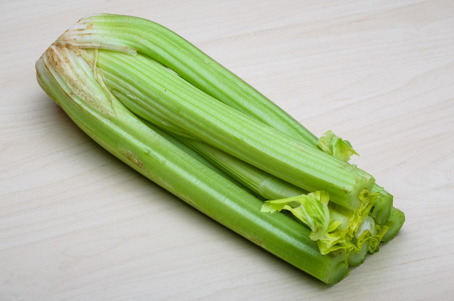 Celery on wooden background photo