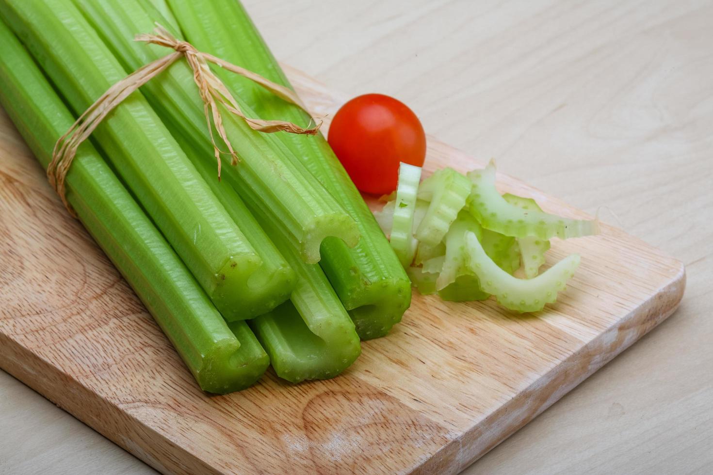 Celery on wooden board and wooden background photo