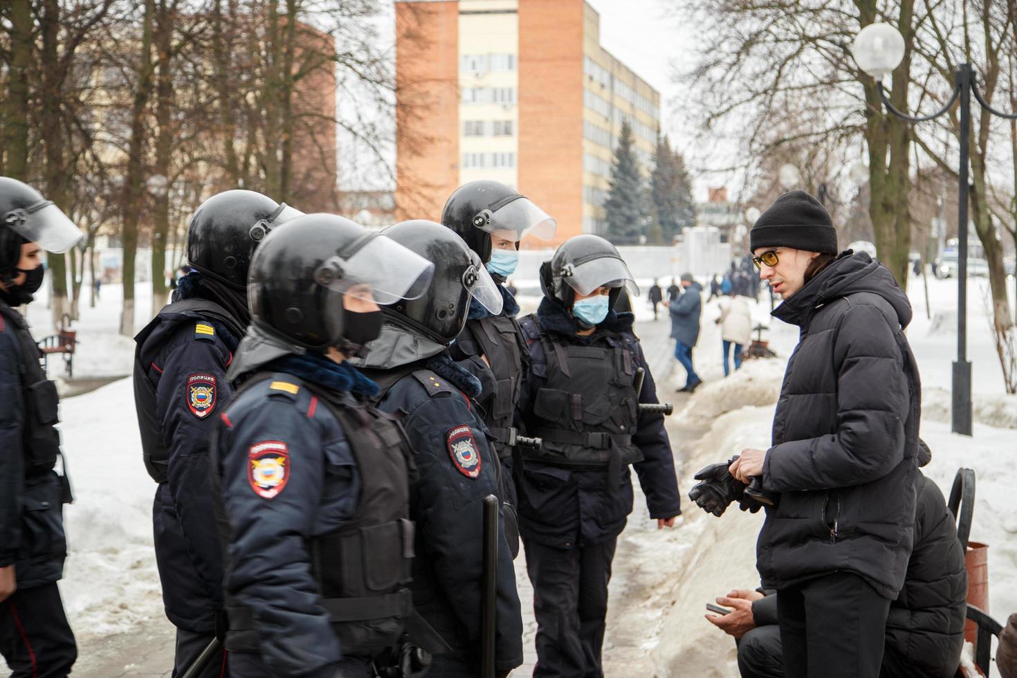 TULA, RUSSIA  JANUARY 23, 2021 Public mass meeting in support of Alexei Navalny, police officers talking with citizens in glasses. photo
