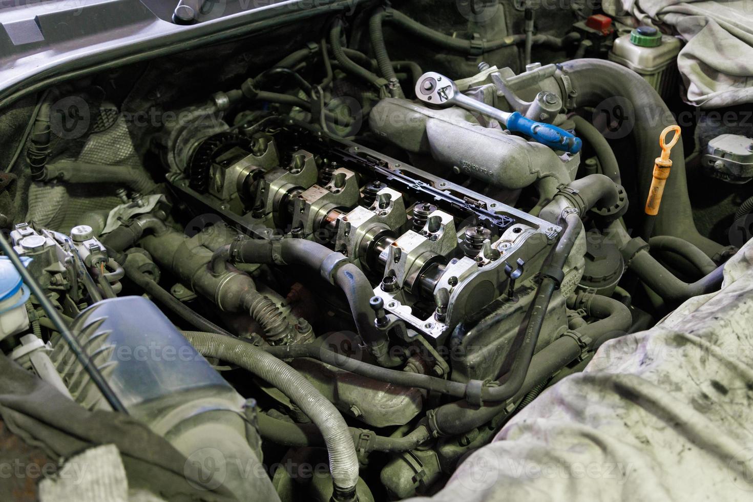 opened diesel internal combustion engine durnig repair inside engine compartment of SUV photo