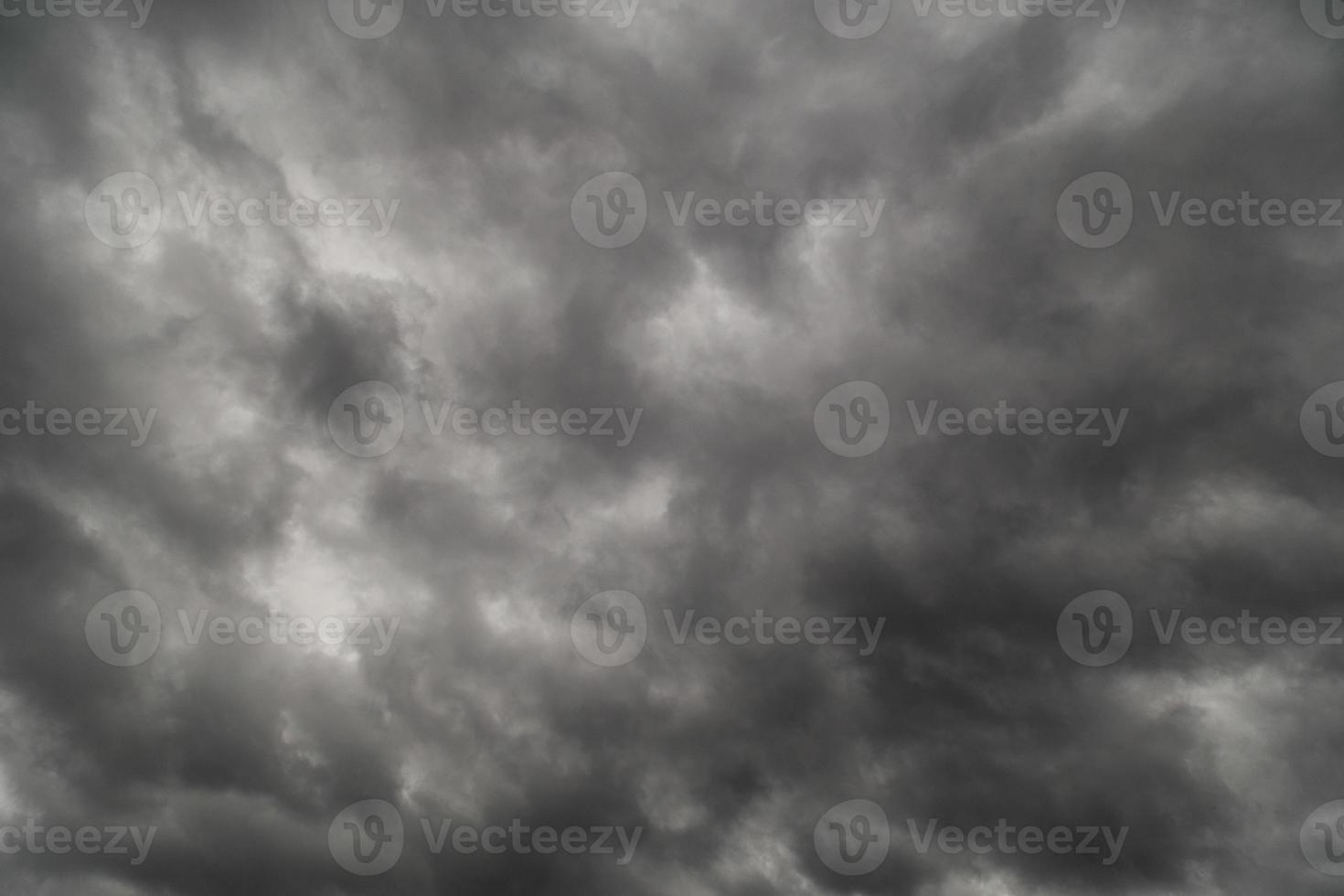 dramatic grey storm clouds background upward view from ground photo