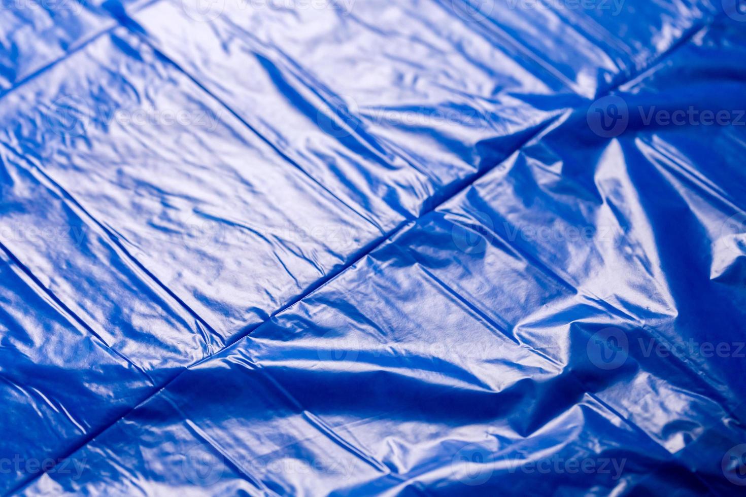 crumpled polyethilene film abstract background with selective focus photo