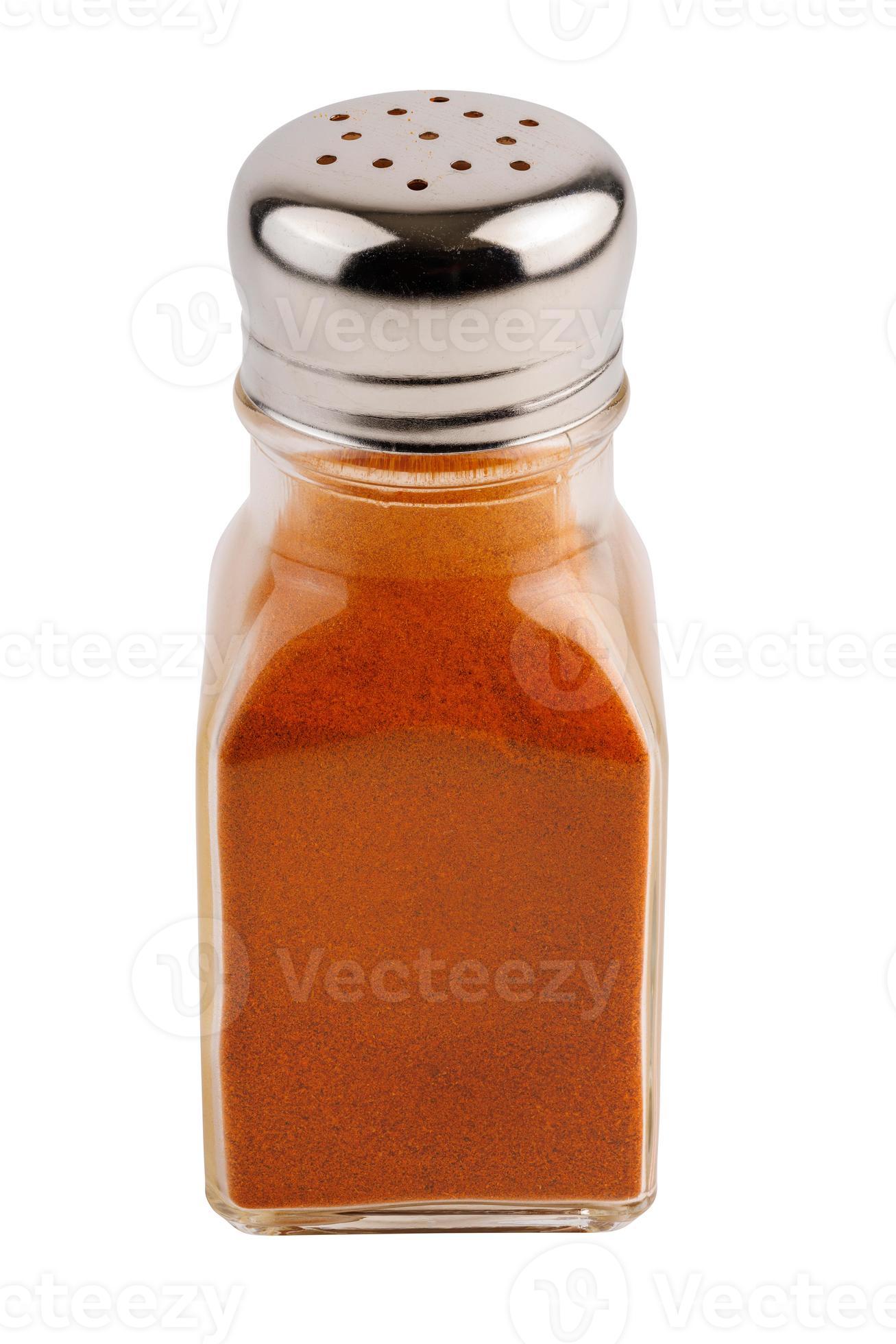 glass pepper pot with ground red paprika pepper isolated on white