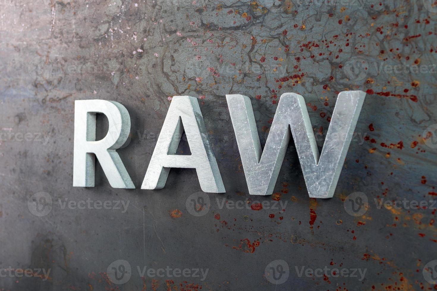 the word raw laid with silver metal letters on hot rolled steel sheet surface photo