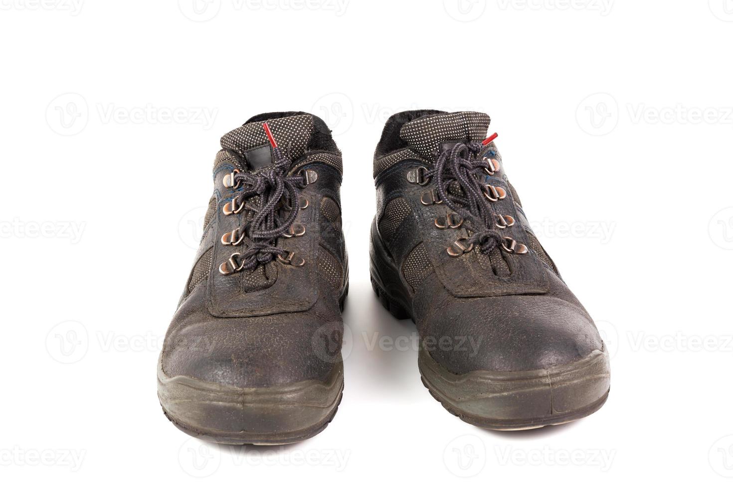 a pair of used blue leather work shoes with fabric incuts isolated on white background photo