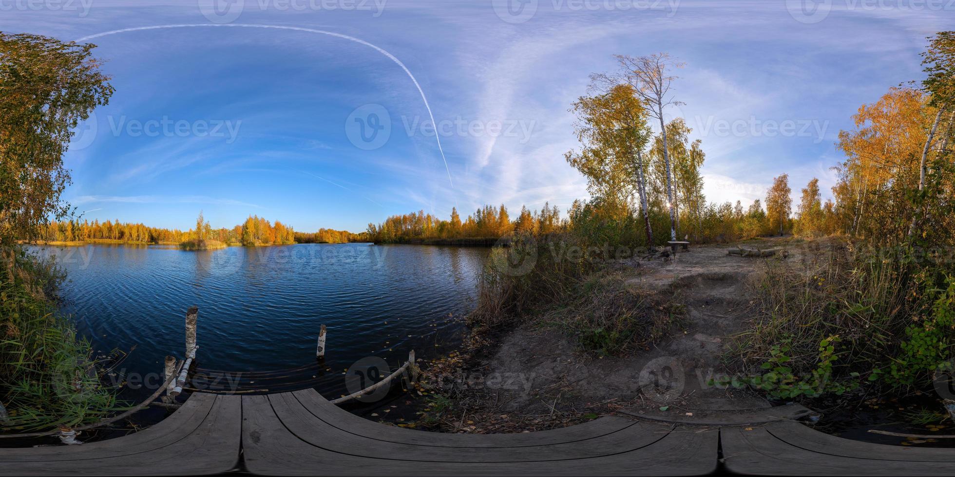 Full spherical 360 by 180 degrees panorama of evening autumnal lake with birch forest on its shores photo