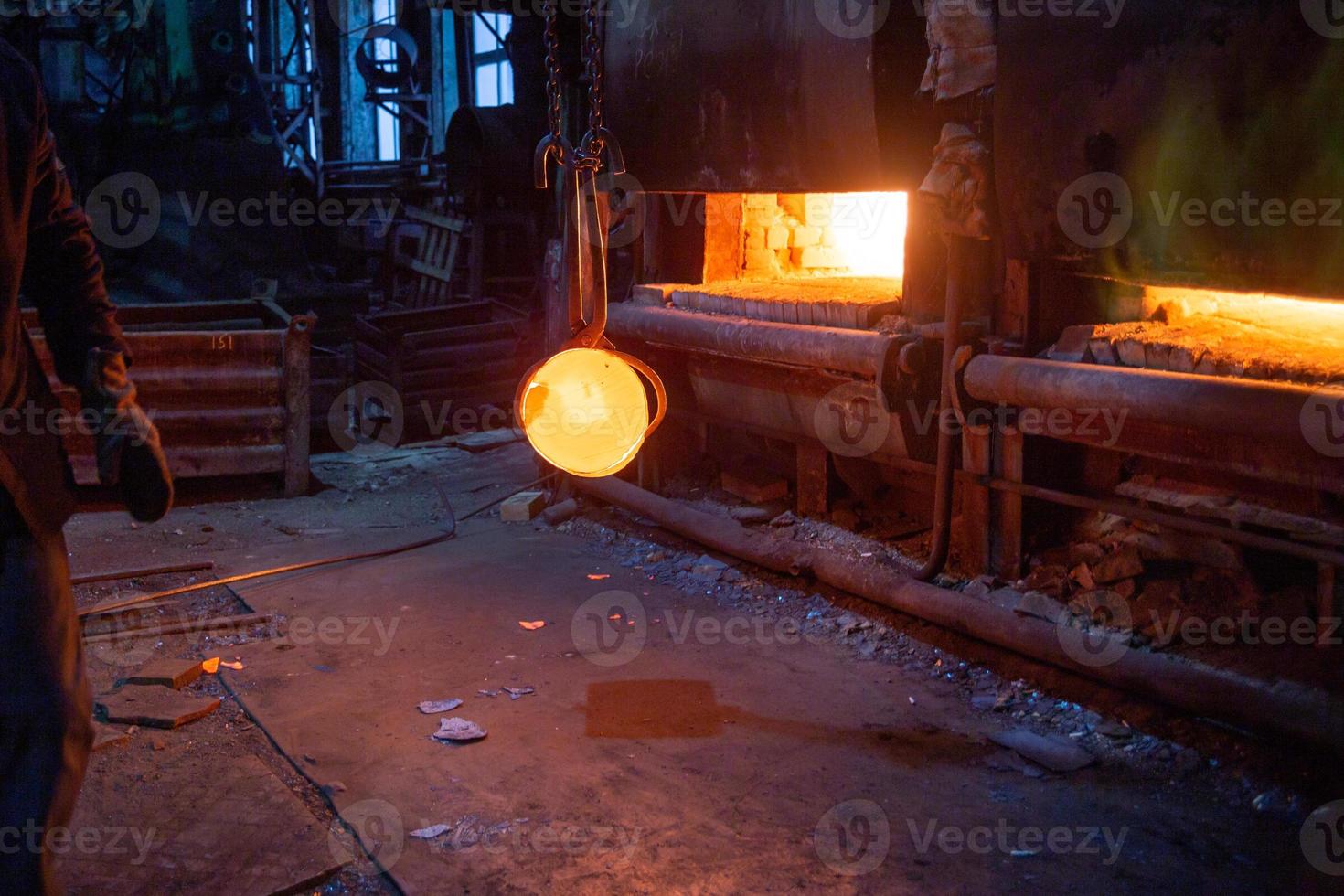 crane moving glowing hot metal workpiece with large self-tighting focreps photo