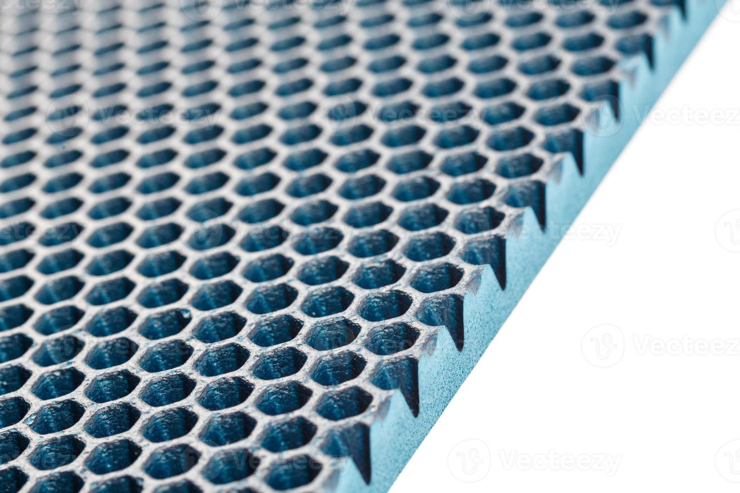 blue hexagonal punched EVA - ethylene vinyl acetate foam carpet linear perspective background with selective focus photo