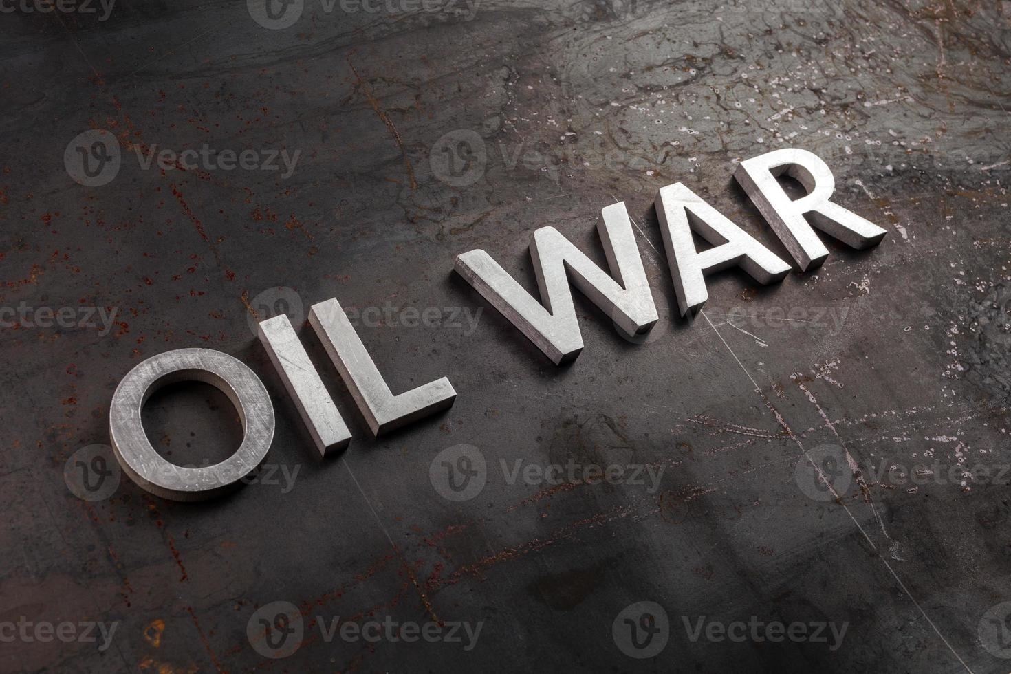 words oil war laid in line with silver metal letters on rusted heavy hot rolled uncoated steel sheet surface in diagonal perspective photo