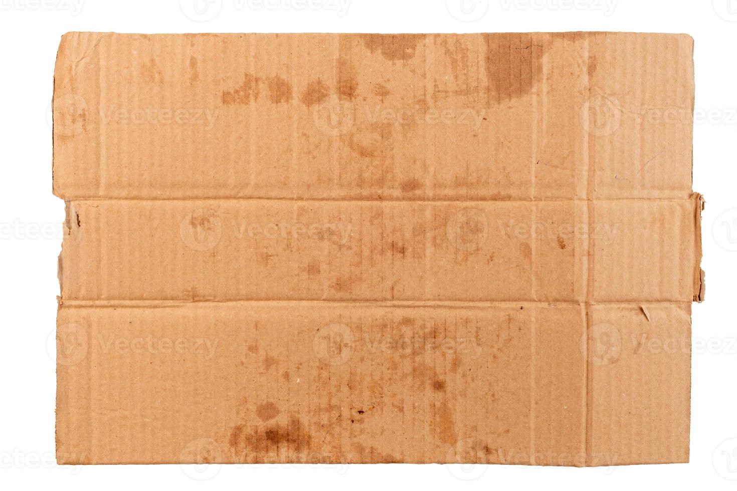 blank flat dirty sheet of yellow cardboard - mockup for homeless placard, isolated on white background photo