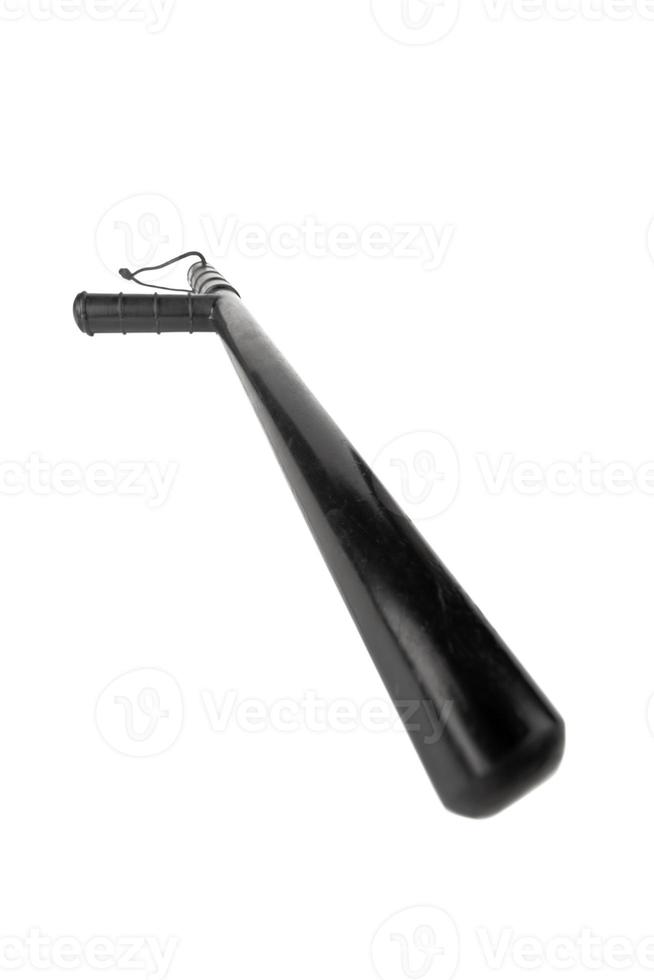 Black classic rubber police tonfa baton isolated on white background with selective focus and wide angle. photo