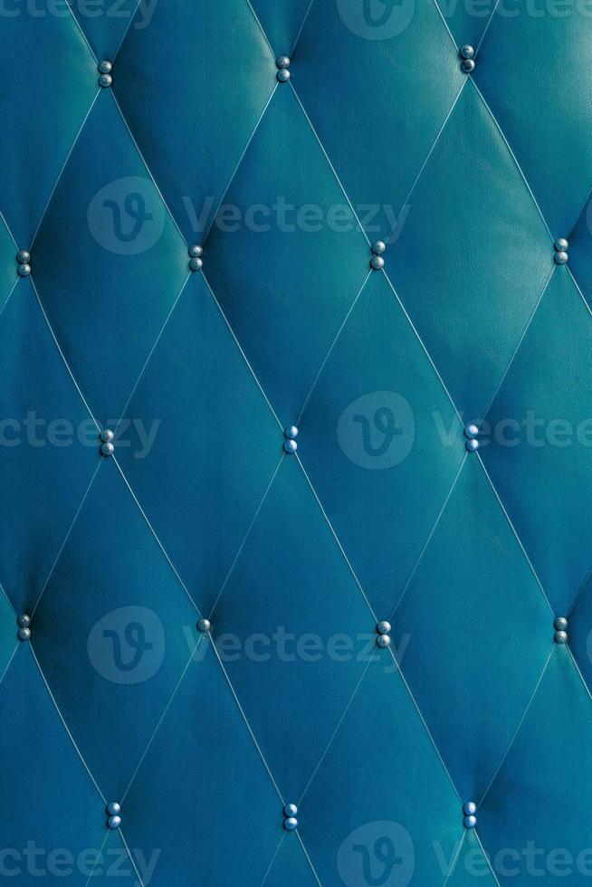 Soviet classic blue brown dermantine front door with a banner of fishing line and nails - full frame background and texture photo