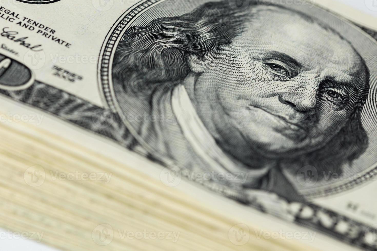 a skewed stack of old us dollar banknotes - close shot with selective focus photo