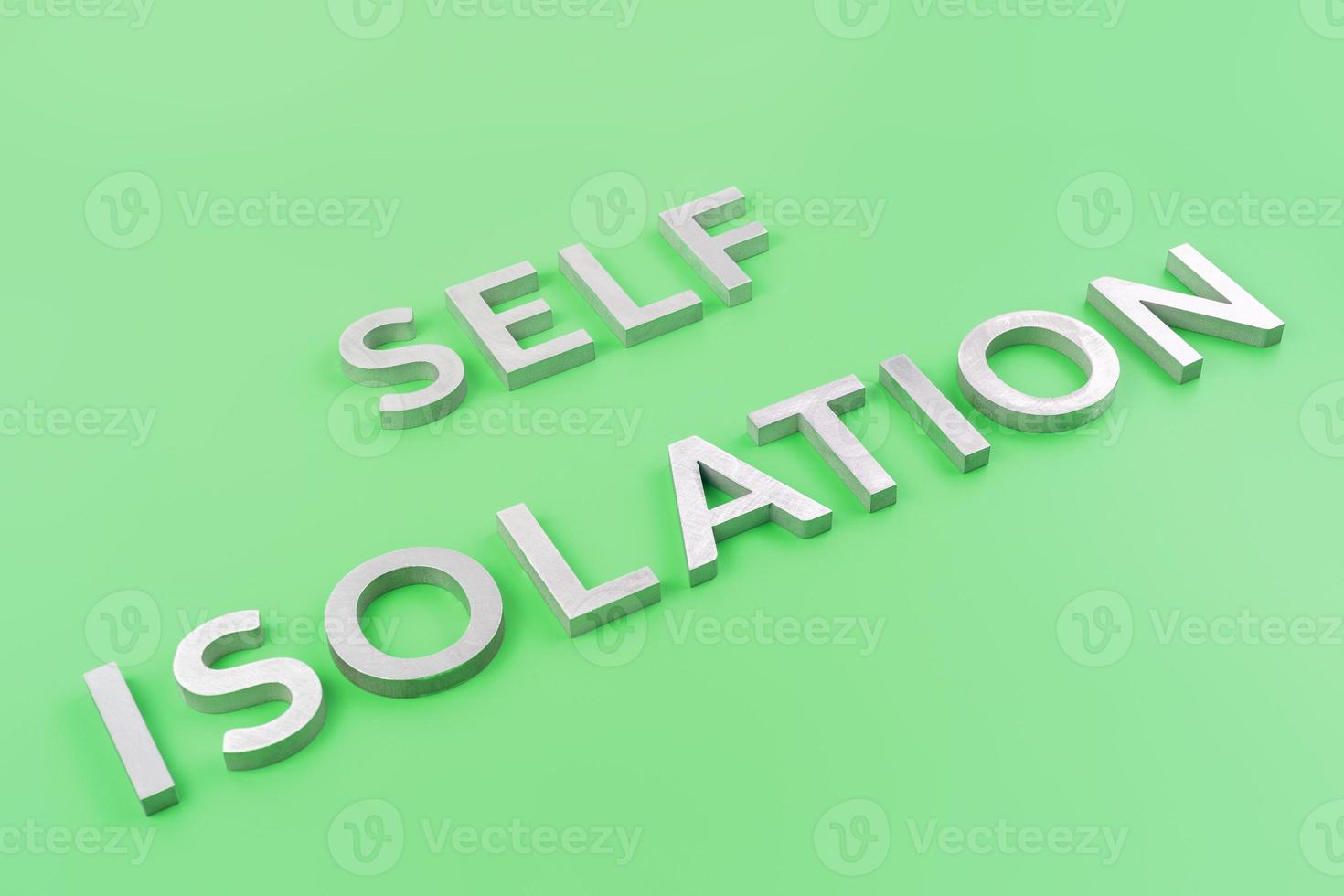 the words self isolation laid with silver metal letters on green background with diagonal slanted perspective photo