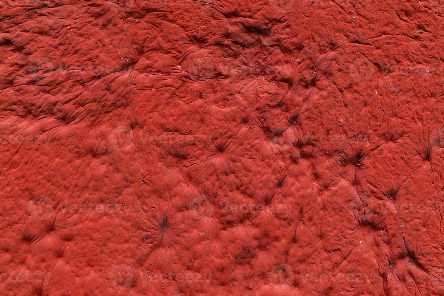red plaster with decorative indentation finish wall texture and background photo