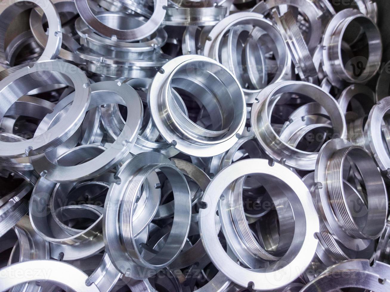 a batch of machined shiny aluminium parts with selective focus photo