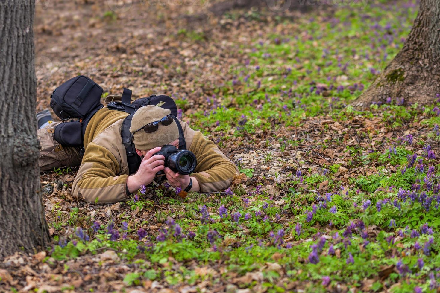professional photographer shooting from grass photo