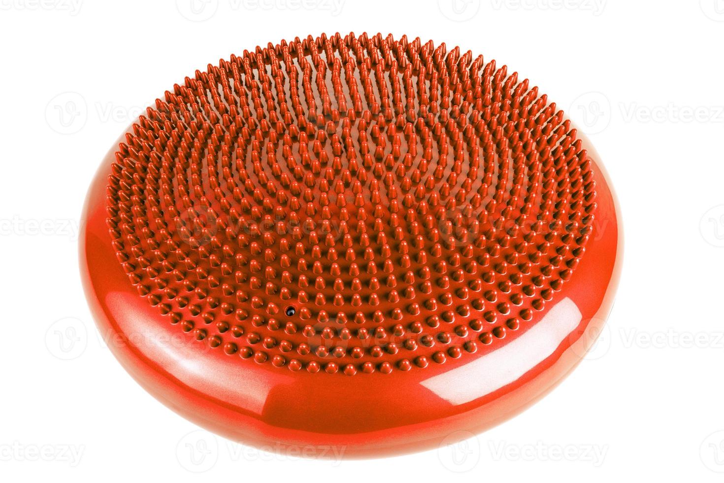 orange inflatable balance disk isoleated on white background, It is also known as a stability disc, wobble disc, and balance cushion. photo