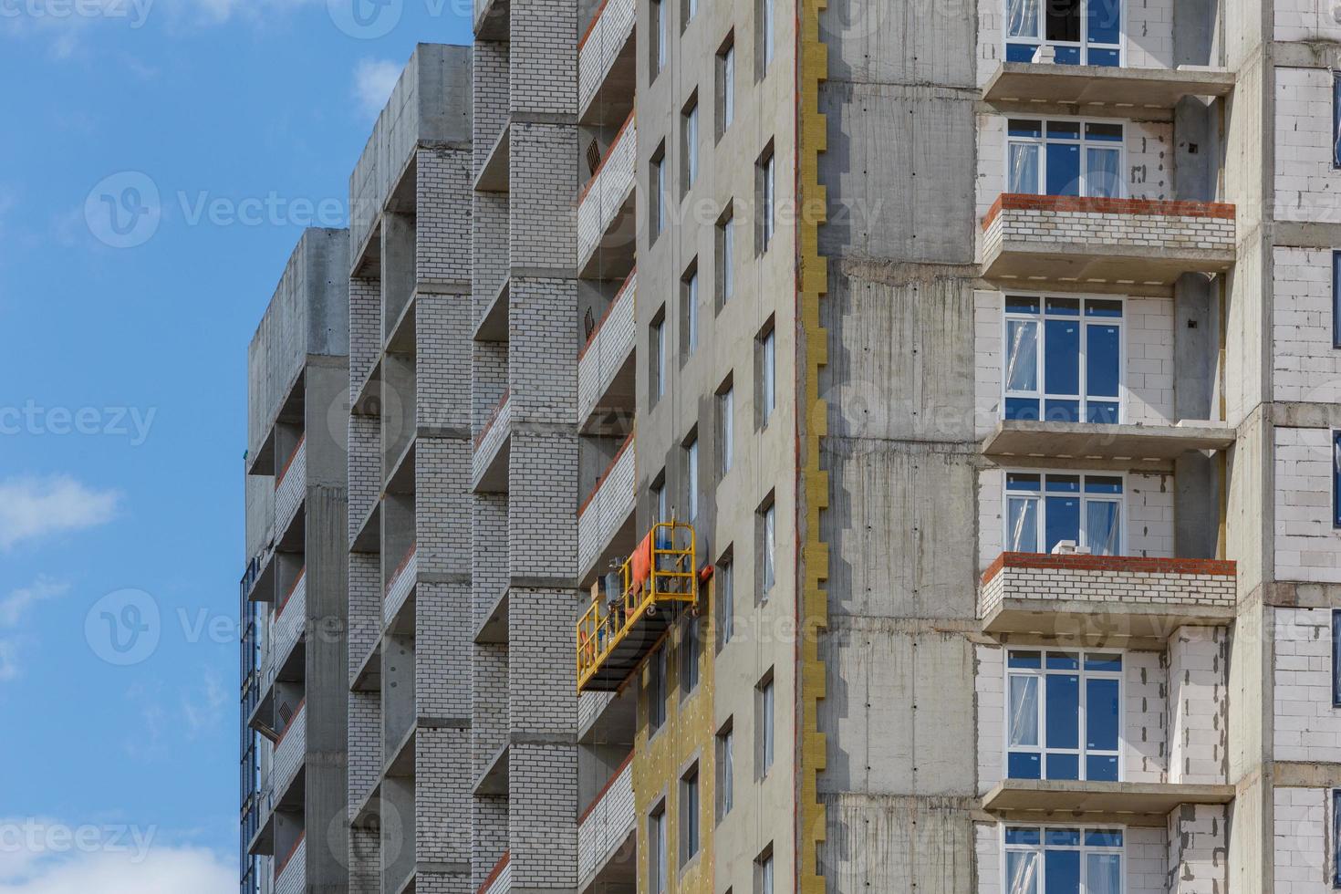 construction cradle on a multi-apartment residential building under construction photo
