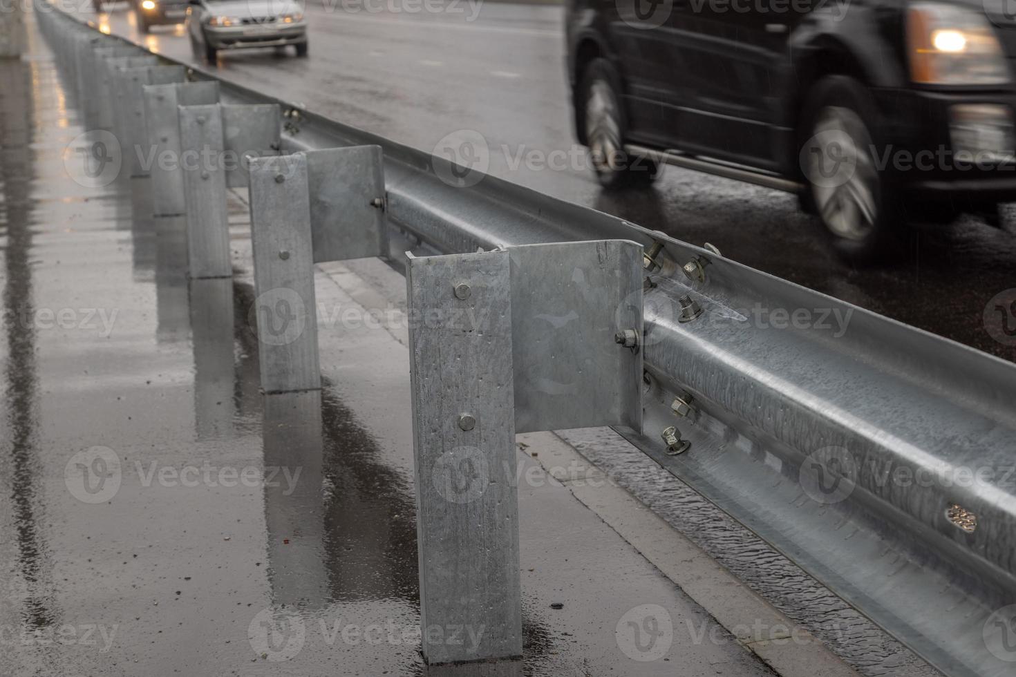 underscrewed nuts and bolts in highway road railing photo