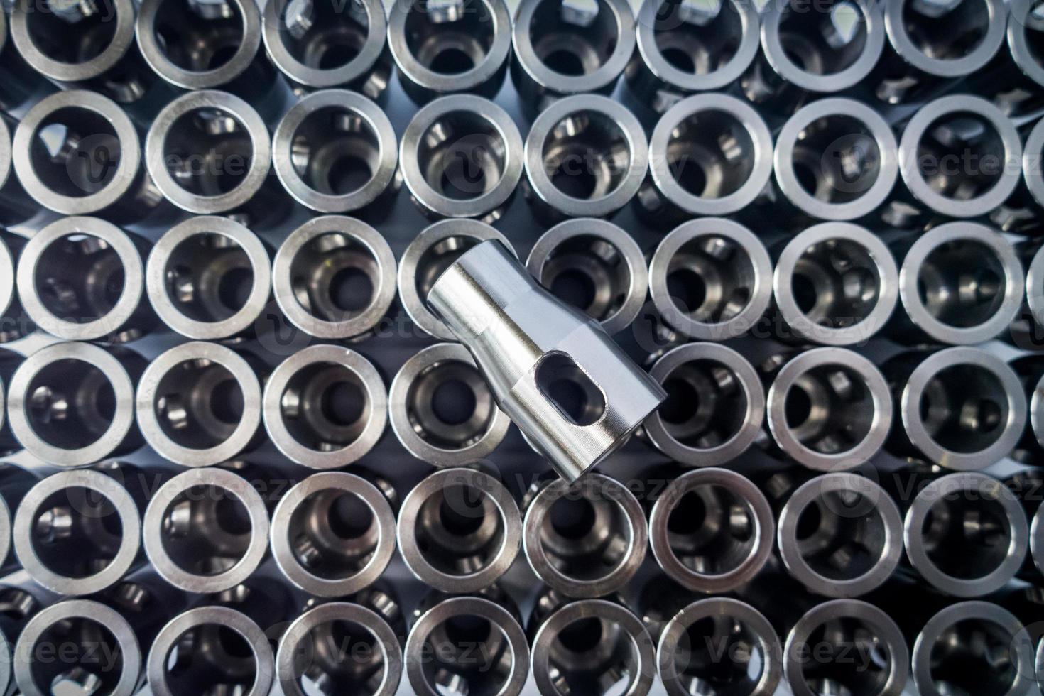 shiny steel parts background - one part sharp in center, others blurred in the background photo