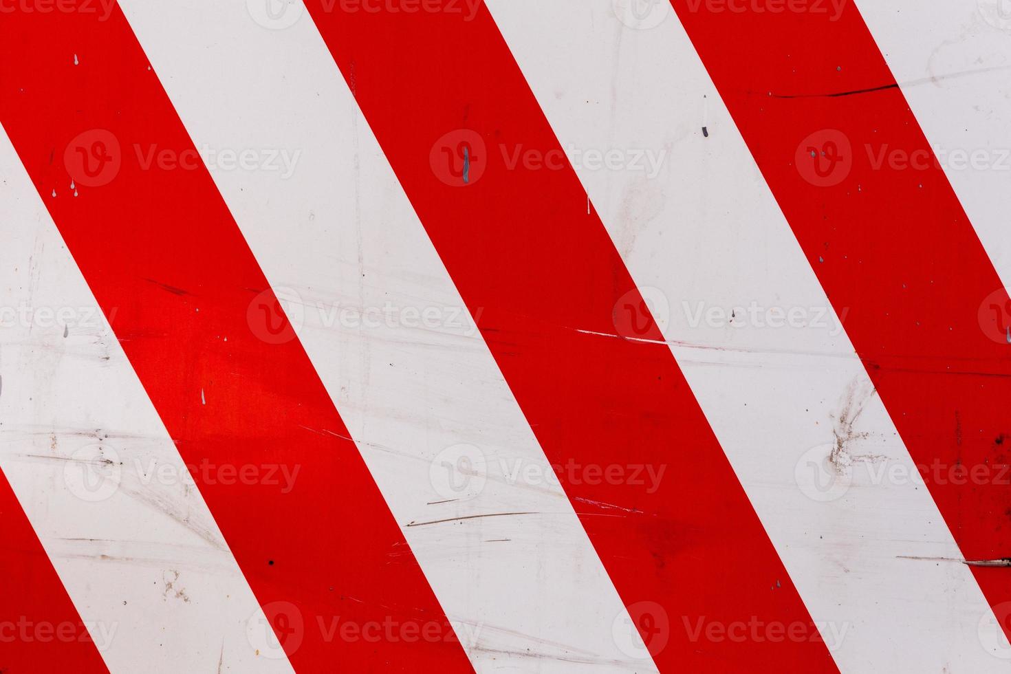 red and white diagonal stipes on flat steel sheet - caution road sign photo