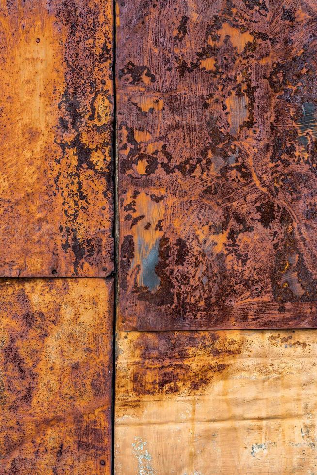 Rusted flat composite nailed metal sheets surface background and texture. photo