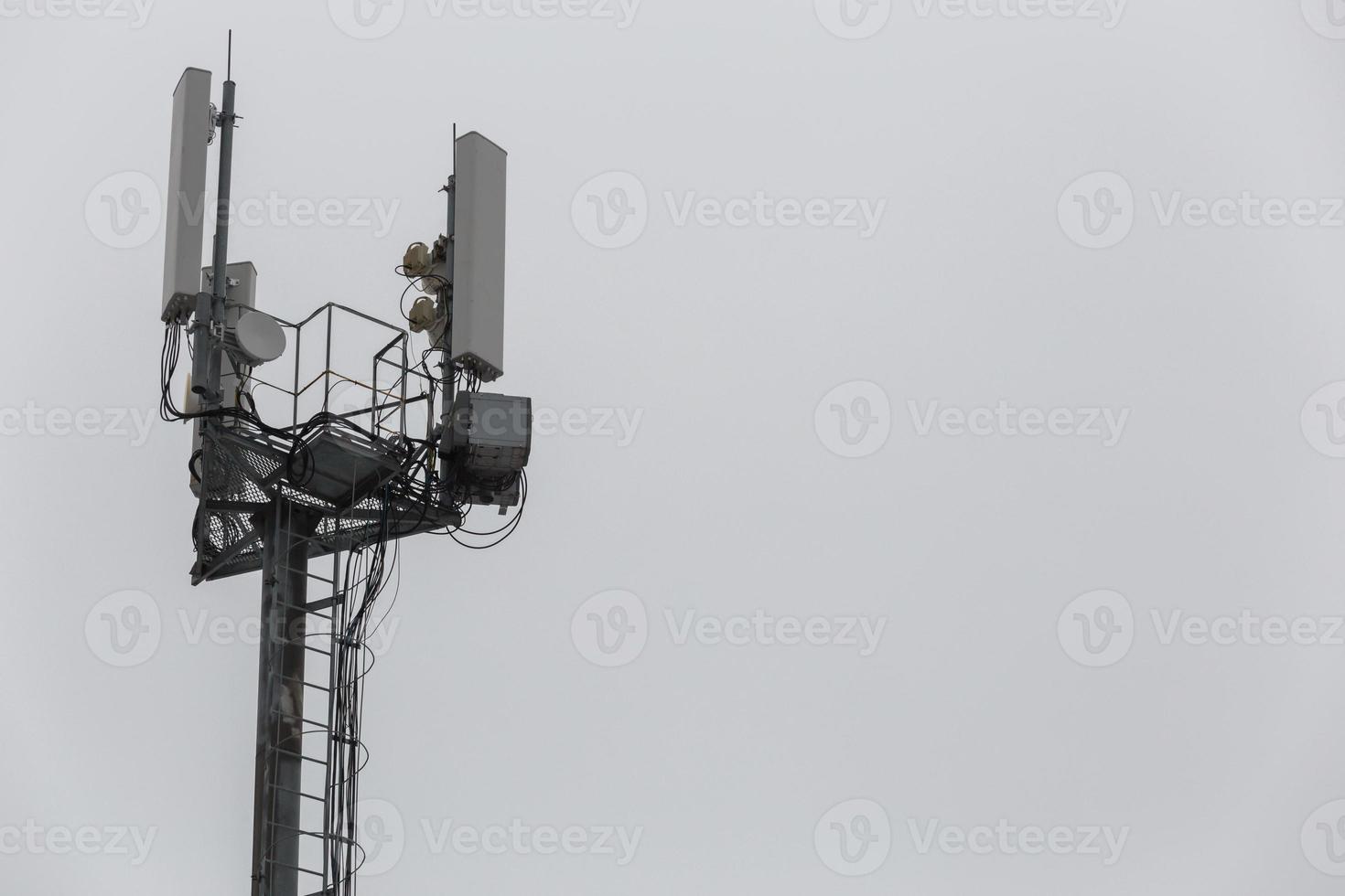 communication and gsm, wcdma, hspda and other 3g, 4g standarts tower close-up in cloudy weather photo