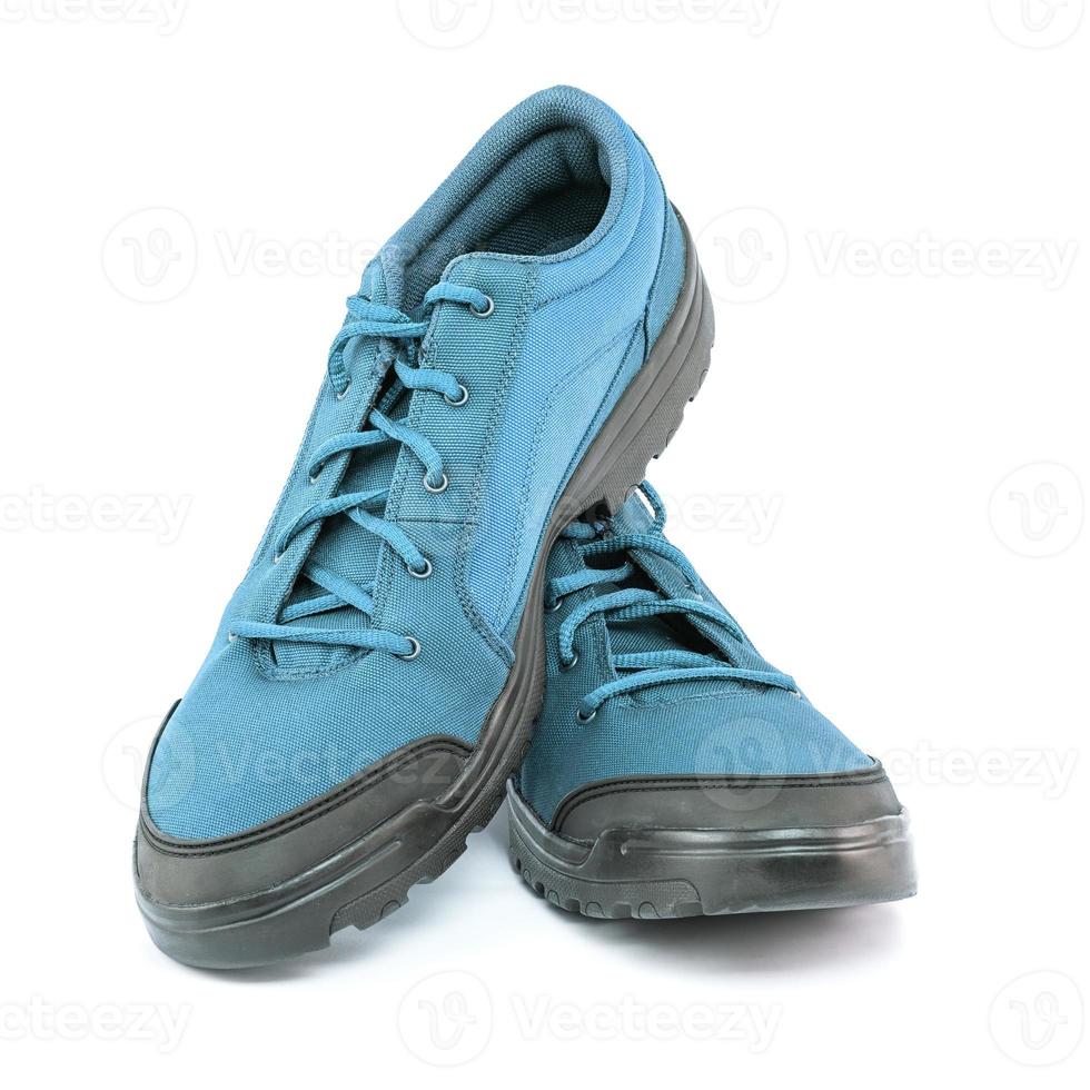 a pair of blue cheap durable fabric travel shoes isolated on white background photo