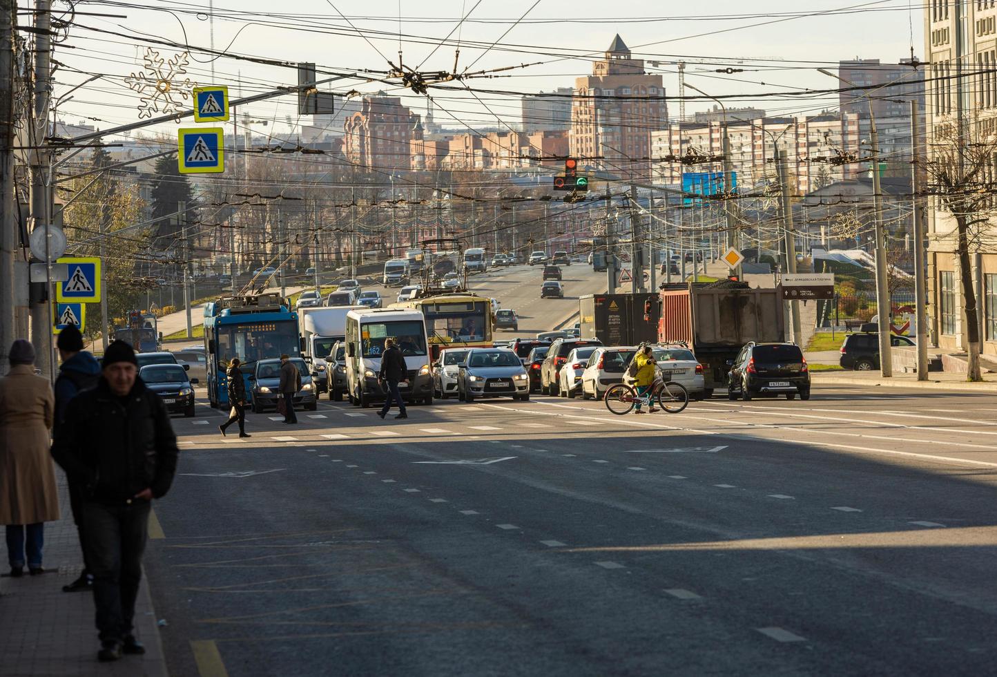 pedestrians crossing the road at the autumn morning sun light in central streets of Tula, Russia - October 23, 2021 photo