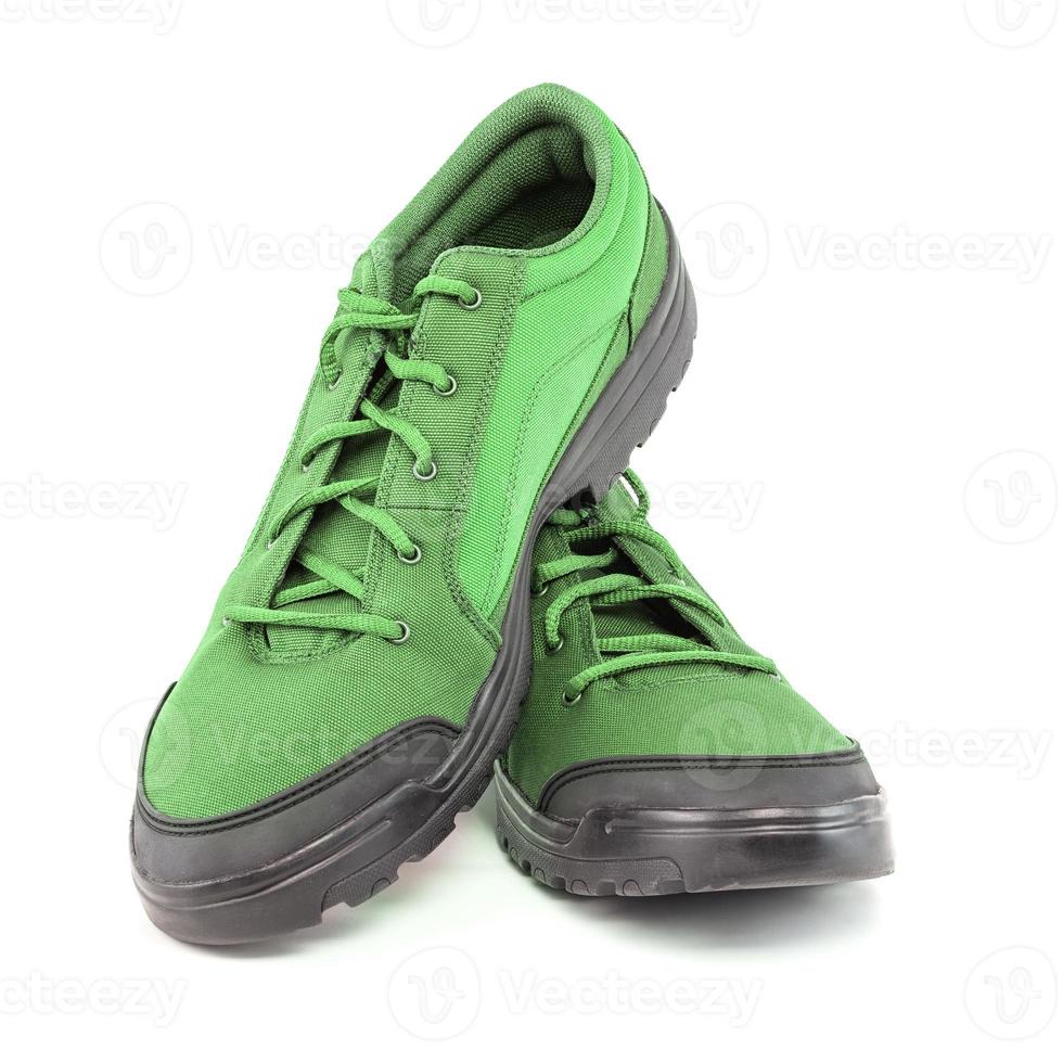 a pair of cheap light green hiking shoes isolated on white background - perspective close-up view photo