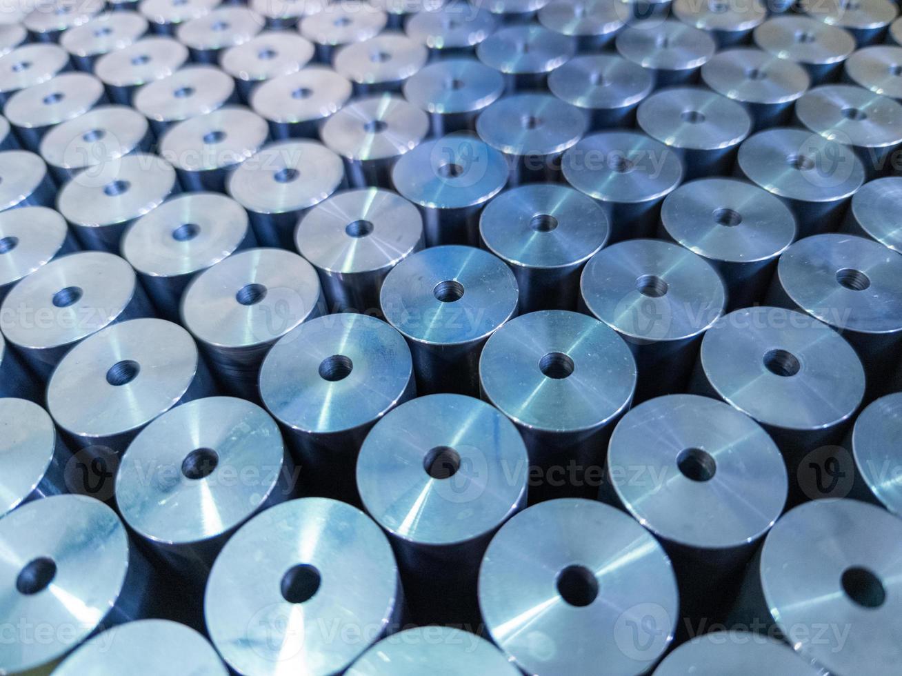 abstract background of shiny steel cylinder parts with central hole photo