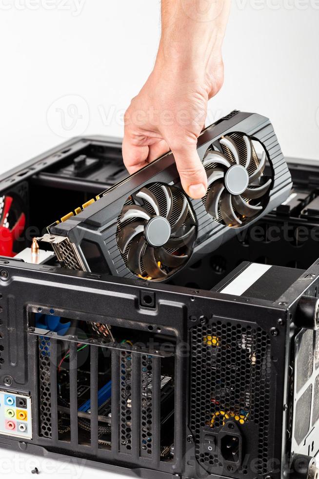 hand plugging a video card while maintenance personal computer hardware photo